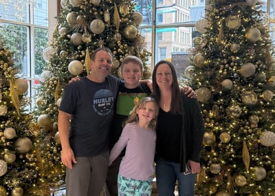 Hannah Bales with he fmaily in fornt of a decorated Christmas tree