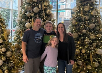 Hannah Bales with he fmaily in fornt of a decorated Christmas tree