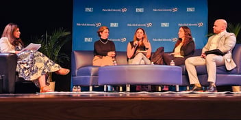 A moderator and four panelists participate in a discussion on stage during Palo Alto University's At the Forefront event, seated in front of a PAU 50th anniversary backdrop.