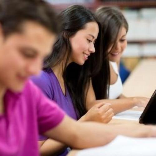 Photo of students reading books and eBooks.